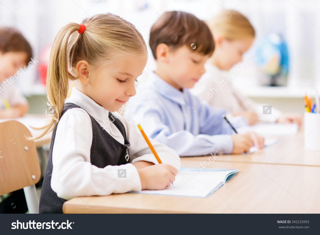 stock-photo-collective-work-little-pupils-are-all-busy-writing-in-their-copybooks-345233993